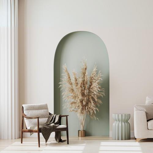 Modern minimalist living room with arched niche and pampas grass decor.