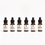 Six amber glass dropper bottles labeled with different essential oil scents: Jasmin Citrus, Nordic Forest, Green Mandarin, Eucalyptus, Lavender, and Bourbon Vanilla.