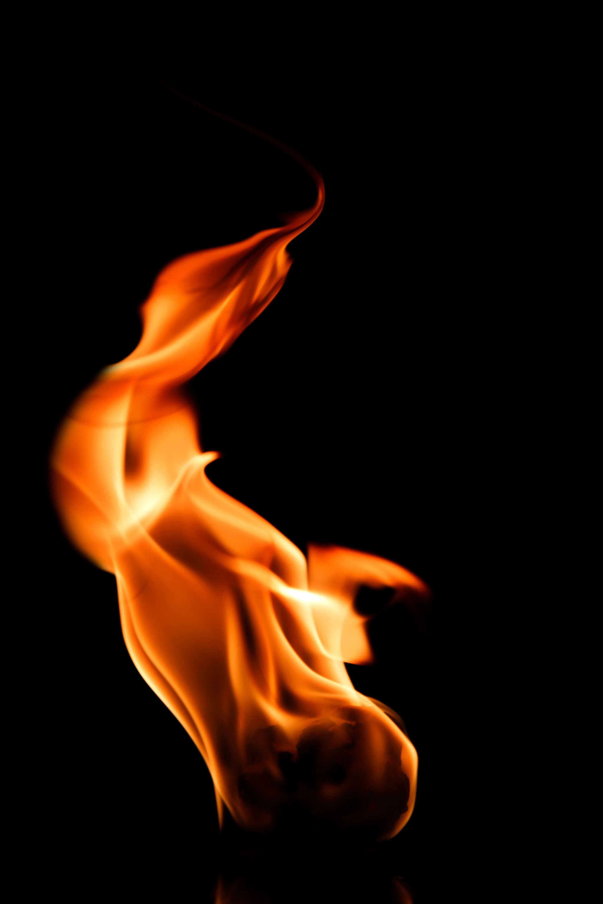 Bright orange flame with dynamic, swirling shapes against a black background.
